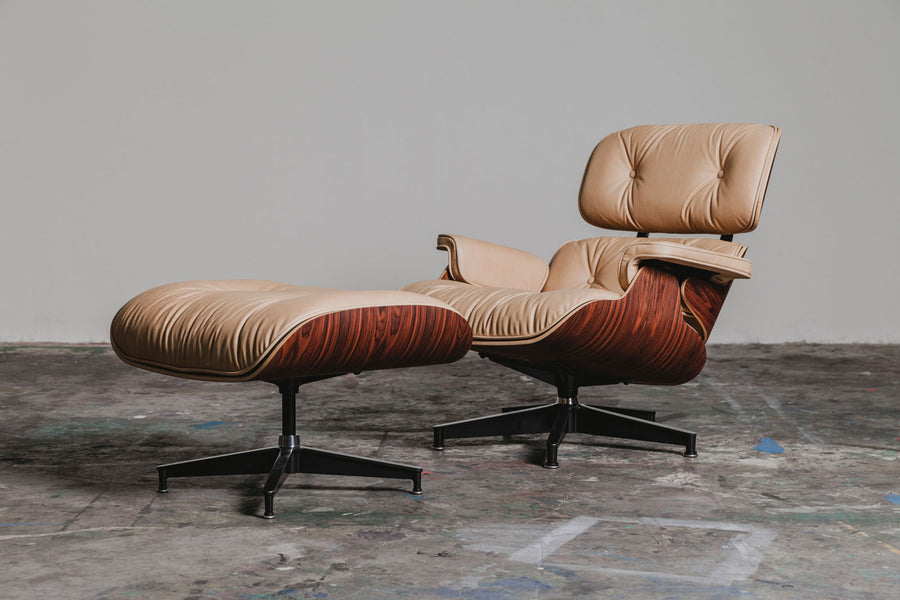 A custom vegetable tanned Eames chair in a blank room.