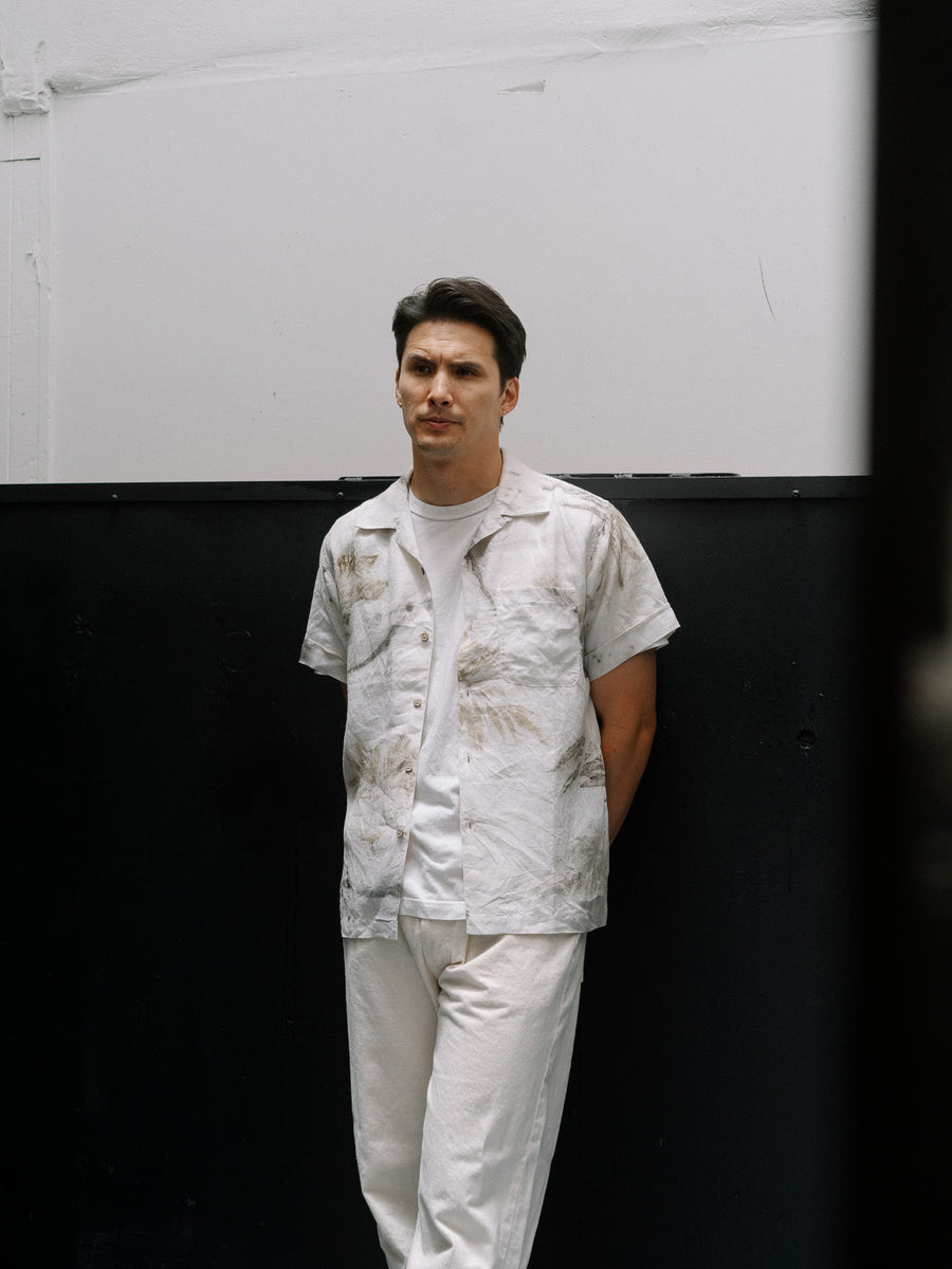 Man standing wearing leaf shirt