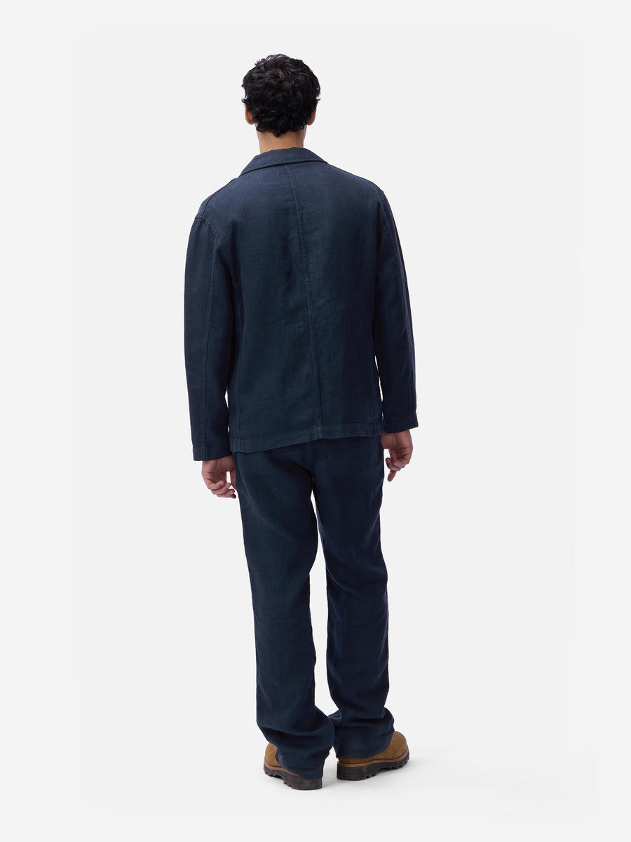 Person wearing a navy blue outfit on a white background