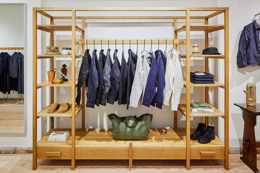 Our collection hangs on wooden racks, surrounded by our favorite accessories.