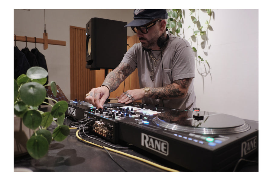 A DJ spinning music on turntables.